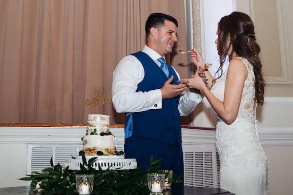 bride and groom cutting a naked wedding cake