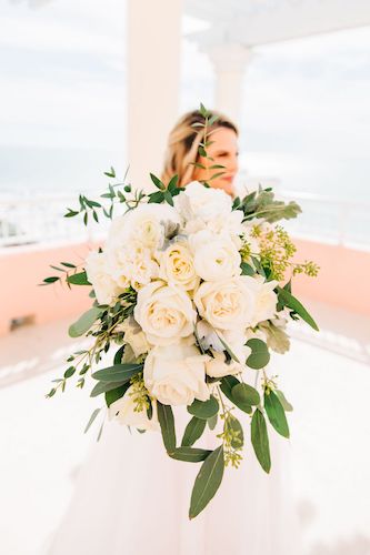 cascading white rose bouquet with greenery and dusty miller