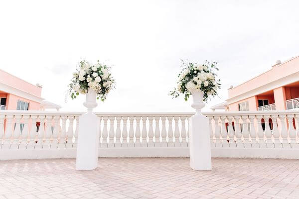 two white urns filled with white flower on the Sky Terrace