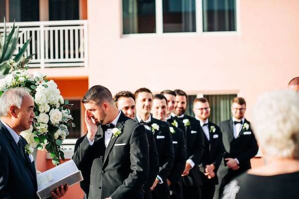 groom tearing up waiting for his brides arrival