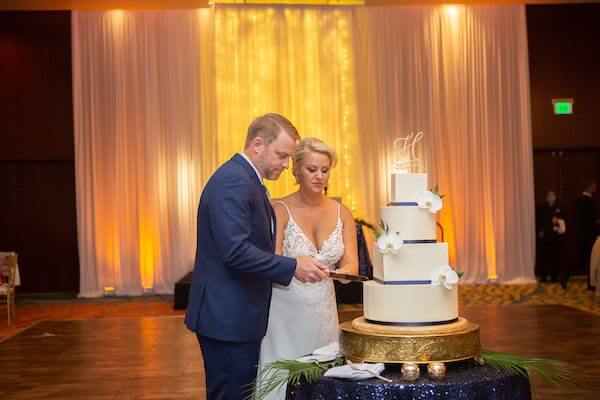 bride and groom cutting their wedding cake at their Clearwater Beach wedding