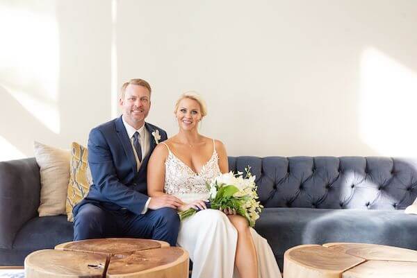 bride and groom sitting on a couch at the Opal Sands Resort Clearwater Beach