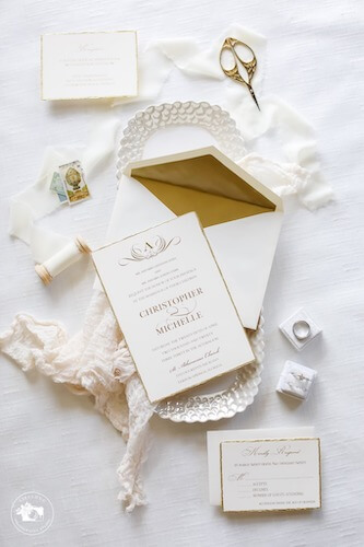 Flatlay photos of brides invitations and accessories