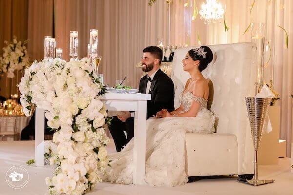 Newlyweds seated at their fairytale sweetheart table