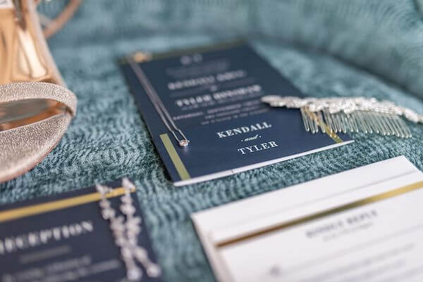 navy blue and gold wedding invitations and bride's accessories