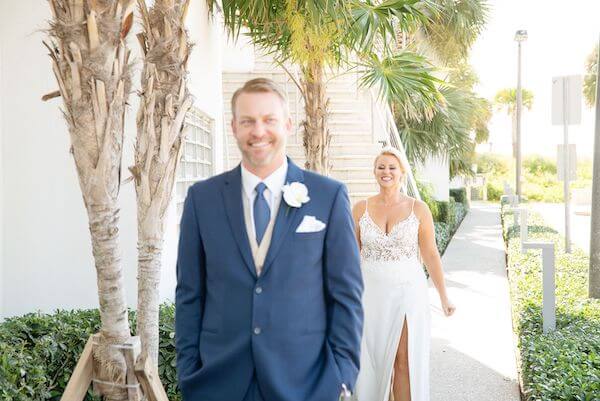 smiling bride and groom anticipating their first look