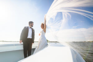 bride and groom on her families boat after their Saint Petersburg wedding