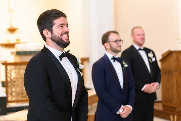 Smiling groom waiting on his bride's arrival at Saint Mary's church in Saint Petersburg 