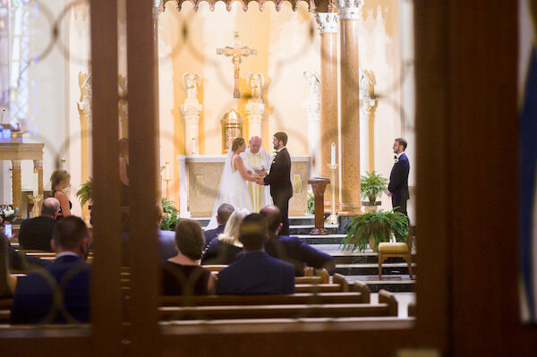 Bride and groom exchanging wedding vows during their Saint Pete wedding