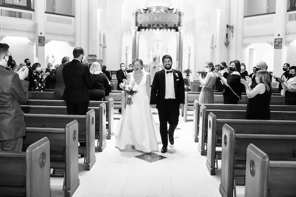 Just married! Happy bride and groom walking up the aisle