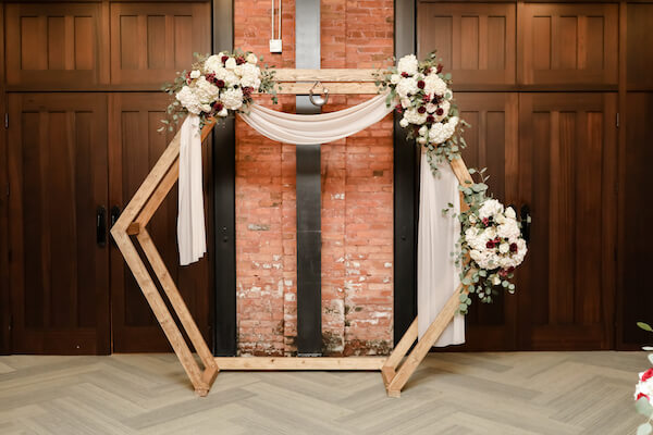 rustic wooden hexagon wedding structure at Tampa's Armature Works