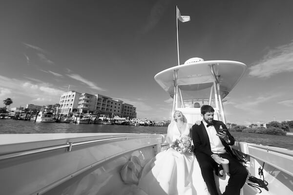 bride and groom on a boat headed to their wedding reception after their Saint Petersburg wedding ceremony