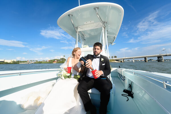 bride and groom on a boat headed to their wedding reception after their Saint Petersburg wedding ceremony