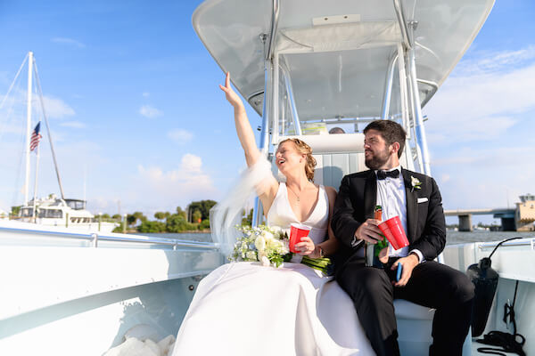 bride and groom on a boat headed to their wedding reception after their Saint Petersburg wedding ceremony