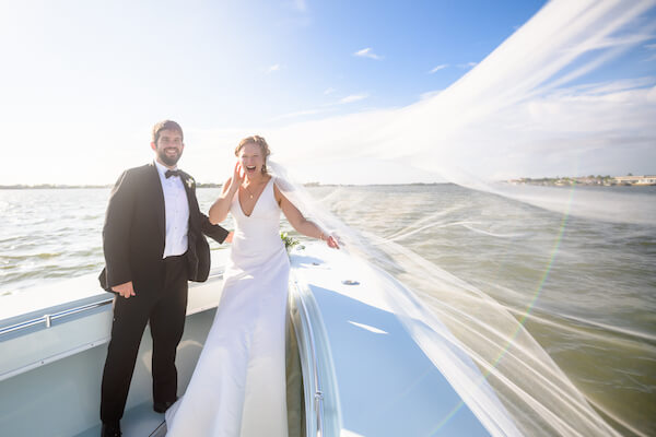 bride and groom on a boat headed to their wedding reception after their Saint Petersburg wedding ceremony