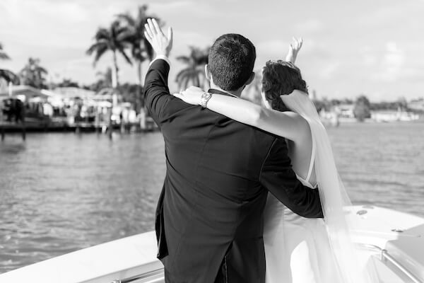 bride and groom on a boat headed to their wedding reception after their Saint Petersburg wedding ceremony