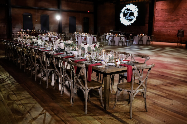 Tampa Armature Works wedding reception with rustic tables and chairs