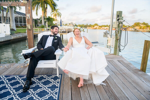 Saint Petersburg newlyweds sitting in chair s on a dock