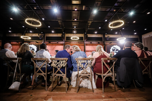 Tampa bride and groom snuggling at their head table during their Armature Works wedding reception