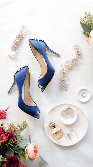 flat lay of Tampa brides accessories and amazing blue wedding shoes with rhinestones