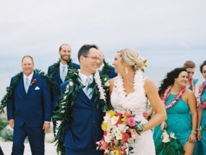 bride and groom on clearwater beach wearing Hawaiian wedding leis