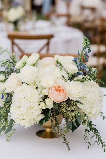 a gold bowl with soft coral and blue flowers for a Clearwater Beach outdoor wedding reception