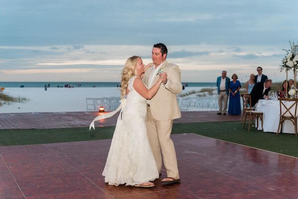 bride and groom having their first dane as the sunset on the Gulf of Mexico 