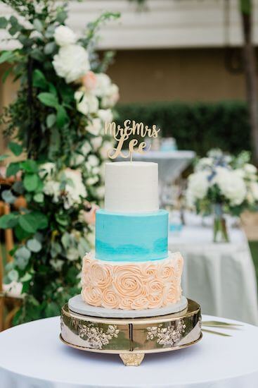 beautiful three tiered wedding cake with subtle beach colors