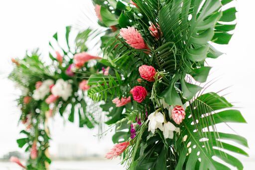 monstera leaves and tropical flowers in an Opal Sand Resort wedding structure on Clearwater Beach