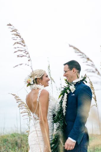 newlyweds wearing traditional Hawaiian wedding leis on Clearwater Beach