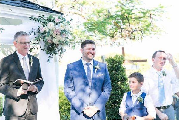 groom and wedding party all wearing boutonnieres pinned on the left side