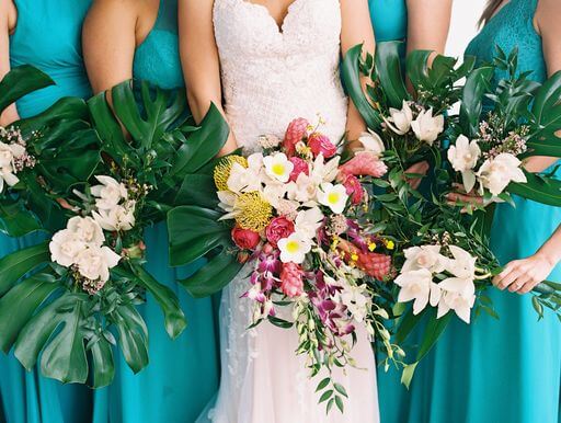 bride and bridal party holding tropical Hawaiian wedding bouquets