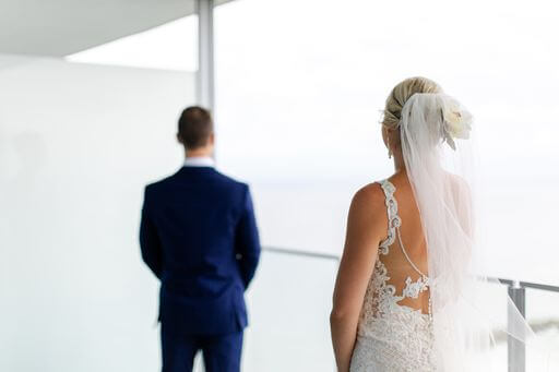 bride walking up behind her groom for their first look