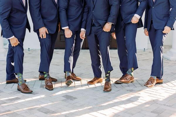 Groom and groomsmen wearing Teenage Mutant Ninja Turtle socks on wedding day