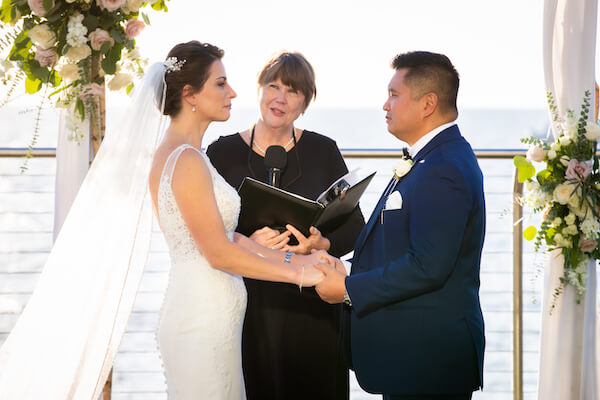 Clearwater Beach couple holding back tears as they exchange wedding vows at the Opal Sand Resort