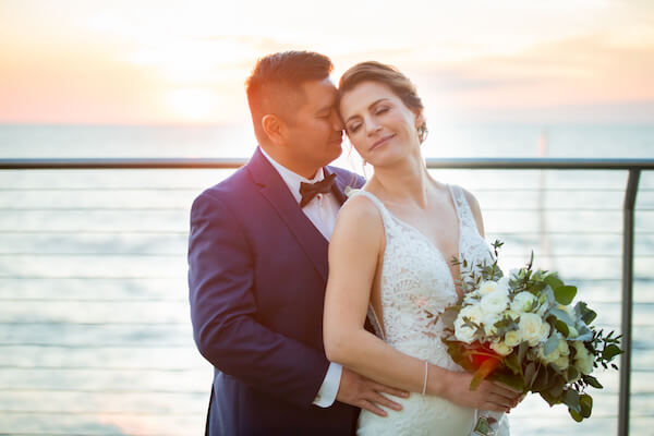 bride and groom as the sunsets outside of the Opal Sands Resort 