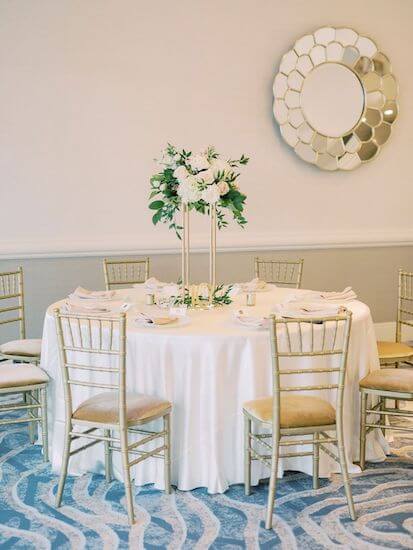 pink and white floral centerpieces on a gold riser at the Hyatt Clearwater