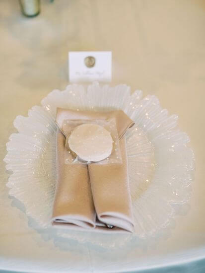 seaglass charger plate with pink napkin and sand dollar cookie