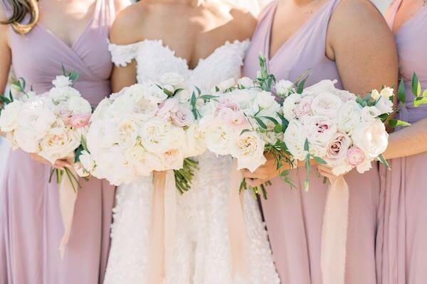 bride and bridal party with lush pink and white bridal bouquets