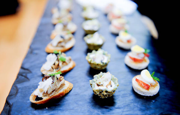 hors d' oeuvres on a slate platter for wedding guests