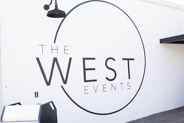 The West Events logo mural alongside the entrance to the Tampa Bay wedding venue