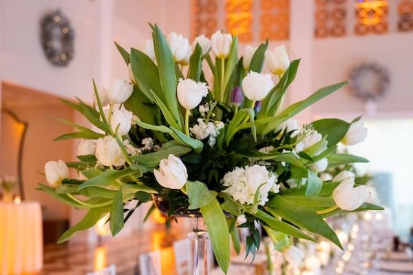 tall centerpiece of white and purple tulips