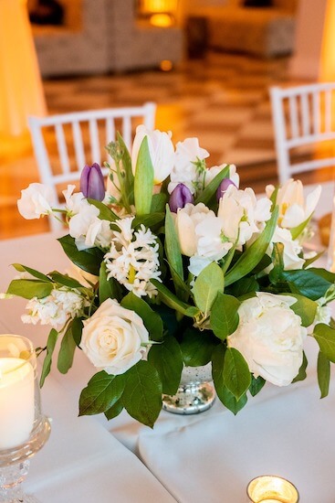 centerpiece of white and purple tulips, peonies and sweetpeas