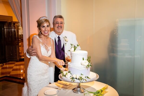 bride and groom cutting wedding cake at their intimate Tampa wedding at The Vault