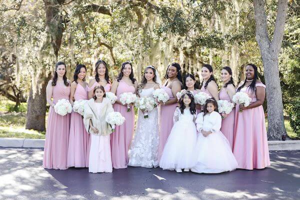 bride with her wedding party in soft pinks with romantic wedding bouquets