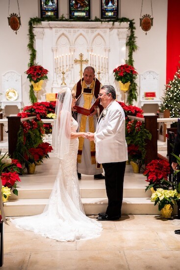 Bride and Groom exchanging wedding vows at the Christmas wedding 