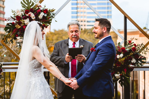 bride and groom exchanging wedding vows during their downtown St Pete rooftop wedding ceremony