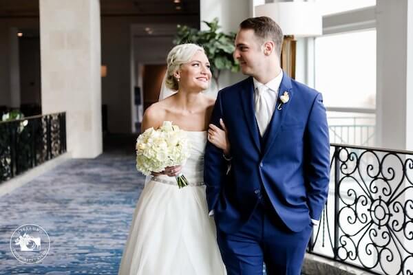 bride and groom walking arm in arm after their first look 