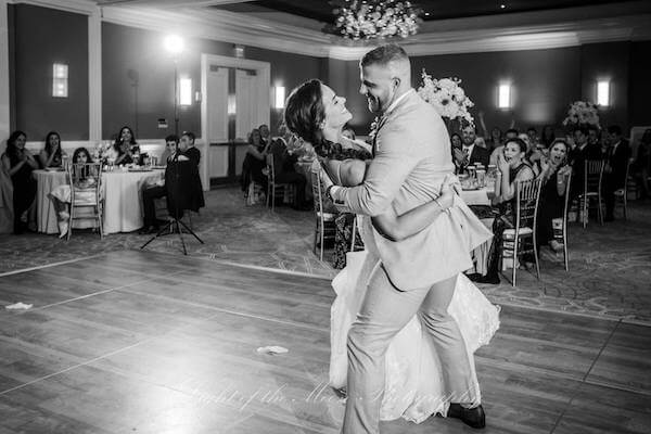 groom dipping his bride during their first dance