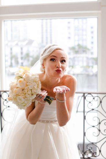 adorable bride blowing kisses at the camera